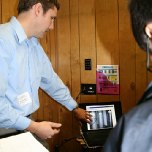 Engineer Jacob Moeder shows students examples of engineering projects.