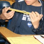 A student ponders a sliderule and how it might work.