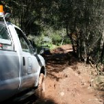 An IRWD truck waits on a muddy road as crews have hiked into the canyon to restore water service to residents.