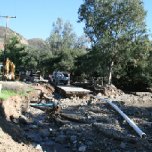 Williams Canyon Road was washed out, along with water mains. Workers construct a water bypass system to supply water to residents.