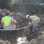 Crews work in a washout to repair water services.