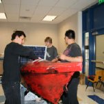 The Solar Cup team installs the wiring and solar panels on the boat. They are looking forward to the race the weekend of May 13-15.