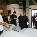 IRWD Water Operator Ken Pfister explains the chlorine canisters to members of the Santa Ana Fire Department.