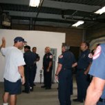 Ken Pfister takes the firefighters through the facility's control room.