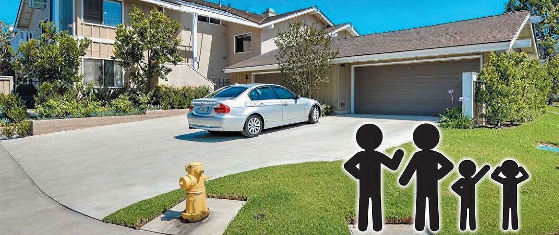 Suburban house with a concrete driveway, a silver car parked, and a family silhouette graphic on the lawn.