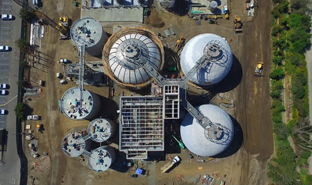 Aerial view of a chemical processing plant with several large spherical storage tanks and metal catwalks