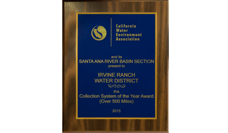 Blue and gold award plaque mounted in a wooden frame recognizing Irvine Ranch Water District for the Collection System of the Year Award (Over 500 Miles), 2015