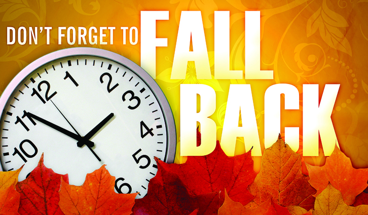 Clock face with autumn leaves and the bold 'Don't forget to fall back' reminder for daylight saving time.
