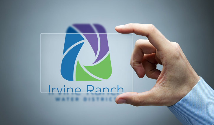 Hand holding a transparent panel displaying the Irvine Ranch Water District logo.