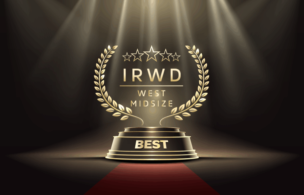 Gold trophy on a pedestal with laurel arches and spotlights, labeled BEST, IRWD West Midsize.