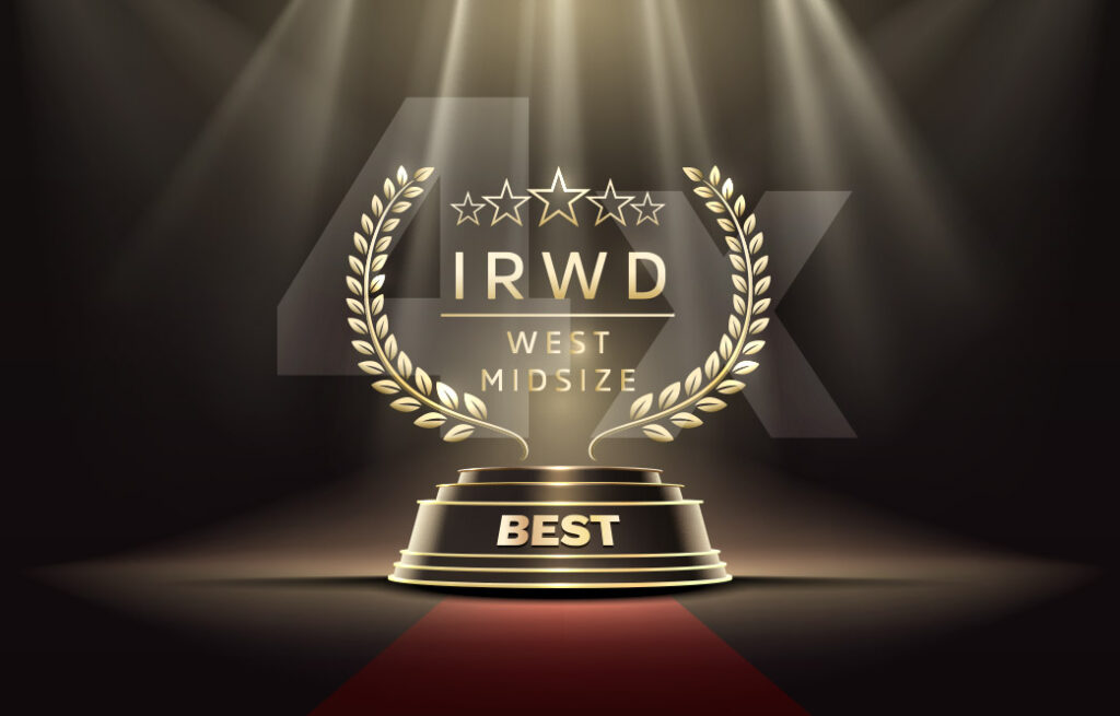 Golden award trophy on a spotlighted stage with laurel wreaths and 'BEST' on the pedestal.