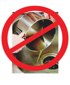 Red prohibition sign over a stainless steel blender blade assembly.