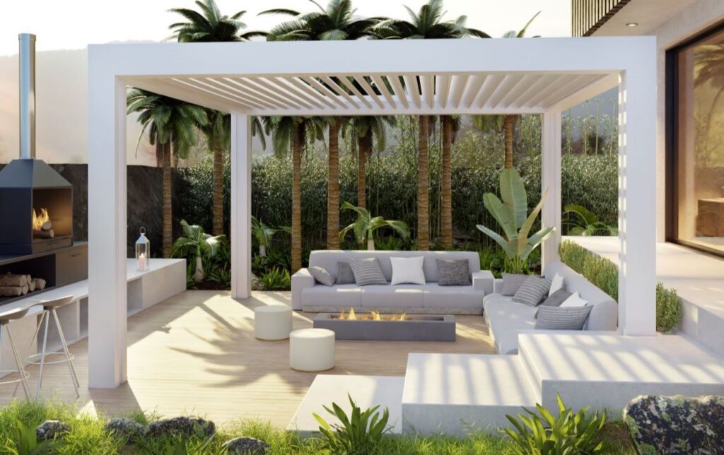 Contemporary outdoor living area under a white pergola with a fire pit and gray sectional seating.