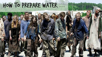Group of zombies in tattered clothing shambling along a street.